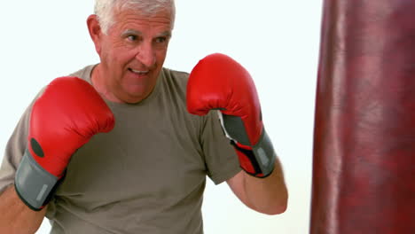 Old-man-hitting-a-punching-bag