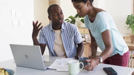 A-diverse-couple-discusses-finances-at-home