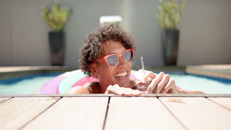 A-young-biracial-man-relaxes-in-a-pool-at-home