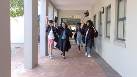 Diverse-group-of-graduates-celebrates-in-a-high-school-corridor