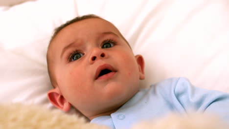 Cute-baby-on-a-bed-with-teddy-bear