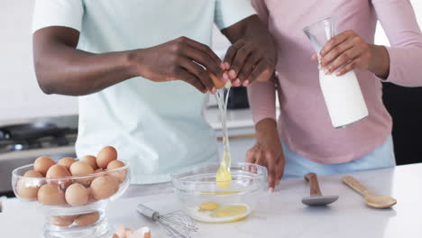 A-diverse-couple-is-preparing-breakfast-together-in-a-kitchen