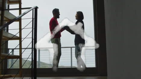 Animation-of-house-shape-over-diverse-couple-dancing-on-balcony