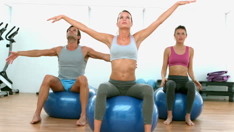 Fitness-class-doing-yoga-on-exercise-balls