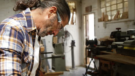 Carpenter-smiling-for-camera-while-reading-plan