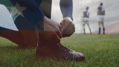 Animation-Der-Chilenischen-Flagge-über-Einem-Kaukasischen-Rugbyspieler,-Der-Auf-Dem-Rugbyfeld-Seine-Stiefel-Bindet