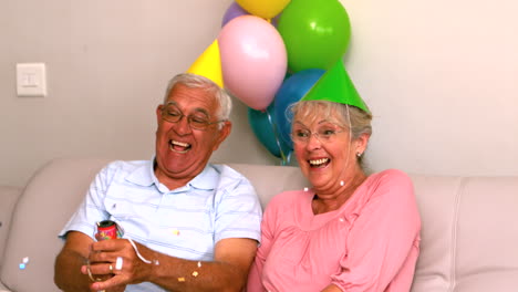 Senior-couple-celebrating-a-birthday-on-the-couch