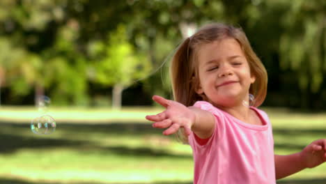 Little-girl-playing-with-bubbles-in-the-park