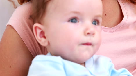 Baby-boy-in-blue-babygro-with-his-mother