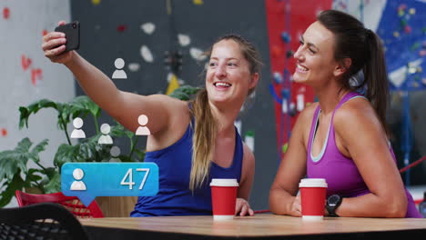 Animation-of-data-processing-over-caucasian-sportswomen-taking-selfie-with-smartphone