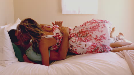 Woman-jumping-on-her-partner-on-hotel-bed