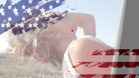 Animation-of-flag-of-usa-over-happy-caucasian-woman-in-car-by-beach-in-summer