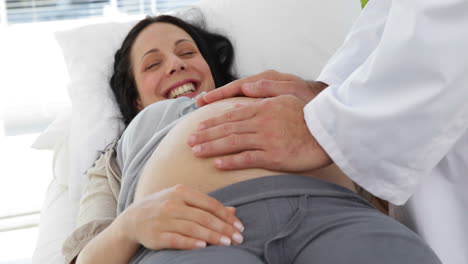 Brunette-pregnant-woman-being-checked-by-doctor