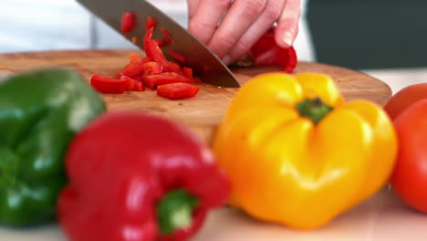 Woman-chopping-a-red-pepper
