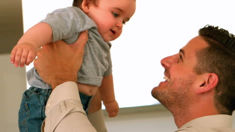 Father-holding-his-baby-son-before-work-in-the-morning