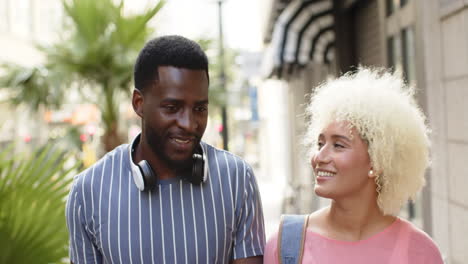 A-diverse-couple-strolls-outdoors-during-city-break