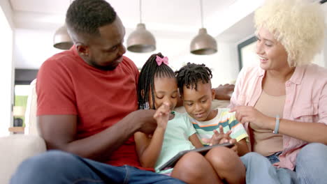 Diverse-African-American-family-sitting-together,-viewing-tablet