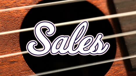 Animation-of-sales-text-over-hand-playing-guitar