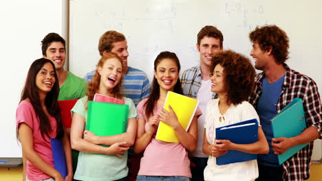 Students-standing-in-classroom-giving-thumbs-to-camera