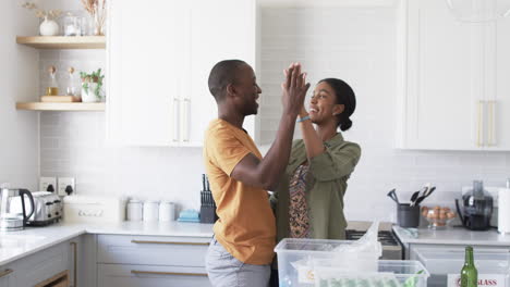 A-diverse-couple-is-in-kitchen-recycling-at-home