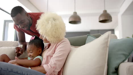 Diverse-family-enjoying-time-together-on-couch-at-home