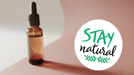 Animation-of-stay-natural-text-and-leaf-logo-over-organic-beauty-oil-dropper-bottle