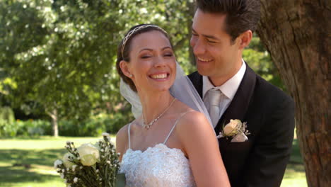 Newlyweds-standing-in-the-park