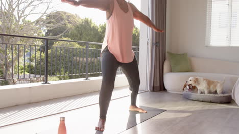 A-senior-African-American-woman-is-practicing-yoga-at-home