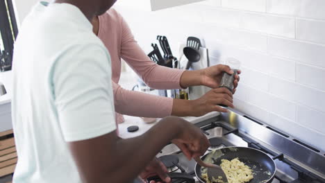 A-young-African-American-couple-is-cooking-breakfast-together