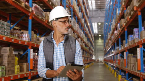 Warehouse-worker-using-his-tablet