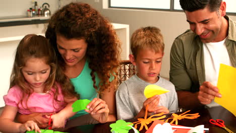 Parents-and-children-making-paper-shapes-together-at-the-table