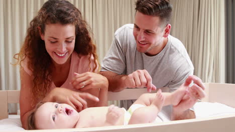 Parents-playing-with-cute-baby-son-in-his-crib