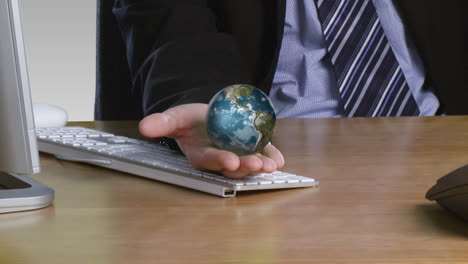 Businessman-with-a-rotary-globe-on-his-open-hand