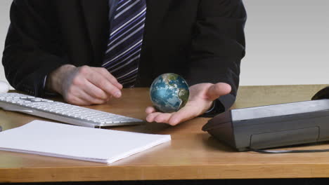 Businessman-with-a-rotary-terrestrial-globe-in-his-open-hand