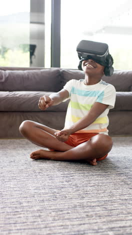 Vertical-video:-African-American-boy-wearing-virtual-reality-headset,-laughing