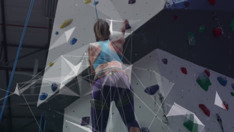 Animation-of-data-processing-over-caucasian-woman-climbing-wall