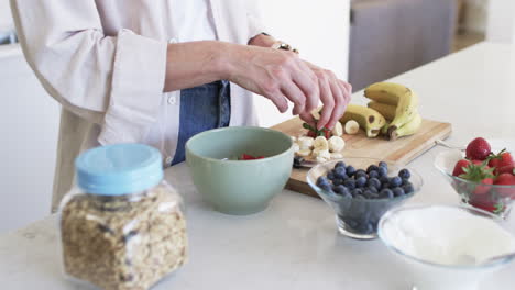 A-middle-aged-Caucasian-woman-is-preparing-a-fruit-salad