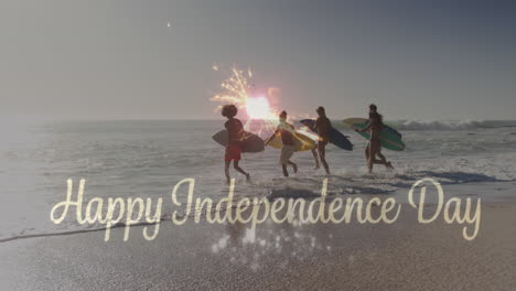 Animation-of-4th-of-july-text-over-fireworks-and-diverse-friends-with-surfboards-on-beach-in-summer