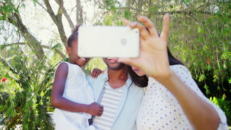 Portrait-of-cute-family-is-taking-selfie-in-the-garden-