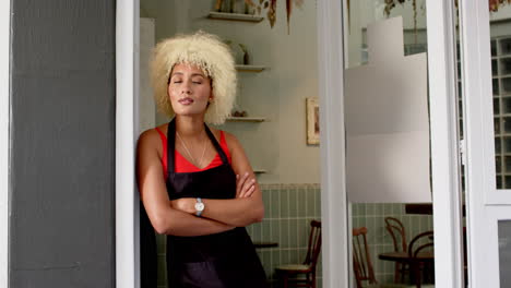 A-young-Caucasian-barista-with-curly-blonde-hair-stands-pensively-with-copy-space