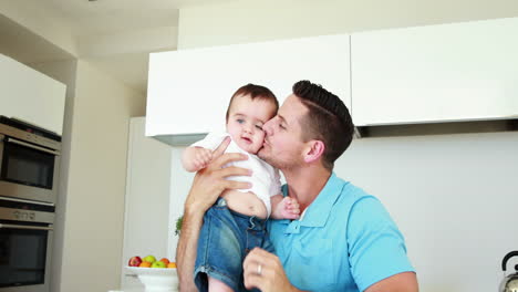 Father-lifting-up-and-playing-with-his-baby-boy