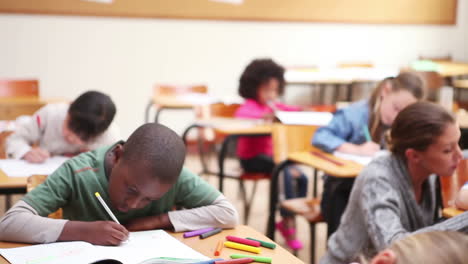 Serious-pupils-writing-on-their-notebooks