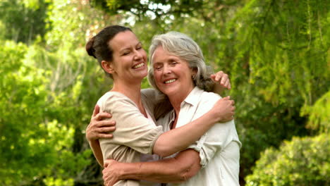 Mother-hugging-her-adult-daughter-in-the-park