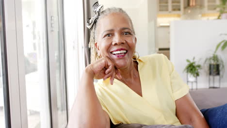 A-senior-African-American-woman-with-bright-smile-sitting-indoors