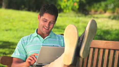 -Man-chatting-on-a-laptop-outdoors