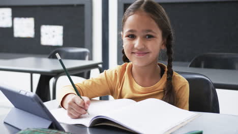 In-a-school-setting,-a-young-Caucasian-girl-is-writing-in-a-notebook