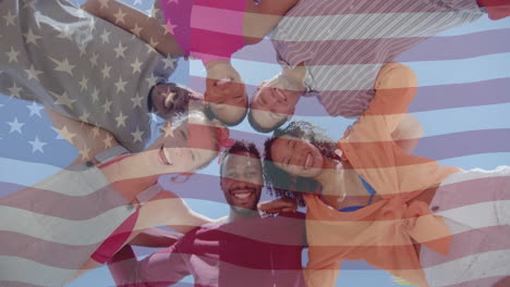 Animation-of-american-flag-over-below-view-of-happy-diverse-friends-embracing-in-the-sun