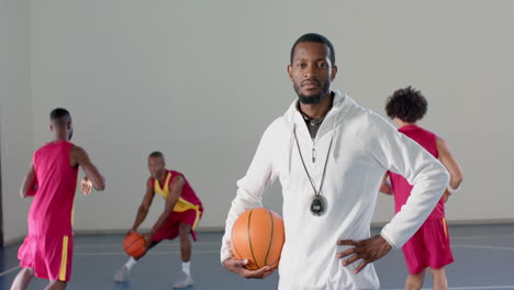 El-Entrenador-Afroamericano-Se-Encuentra-Con-Confianza-Con-Una-Pelota-De-Baloncesto.