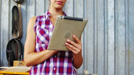 Portrait-of-serious-carpenter-working-on-tablet-pc