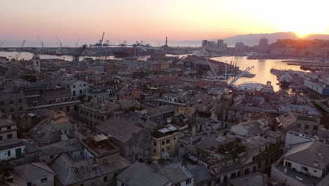 Drone-view-of-Genoa's-historic-center-at-sunset-with-harbor-in-the-background